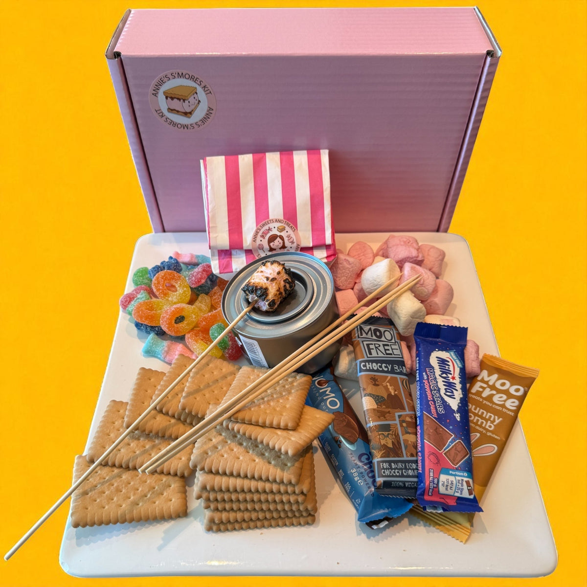 Vegan s’mores kit with dark chocolate and biscuits on a yellow background